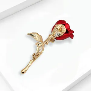 Back view detail of an elegant red and gold rose flower brooch with a pin clasp