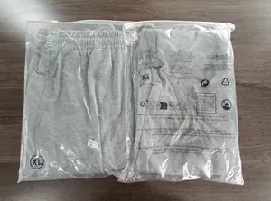 Macro detail of grey men's sports sweatpants packed in professional clear bags