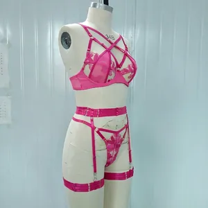 Detailed view of pink floral embroidery mesh lingerie set on mannequin.