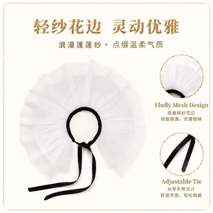 Detail view of the layered white tulle ruff collar with adjustable black ribbon tie
