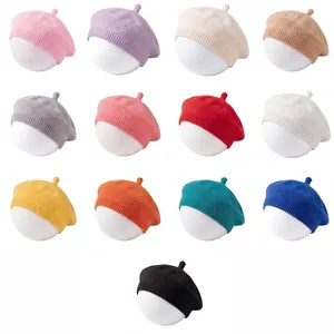 Multiple colors of solid knit baby beret hats for infants and toddlers in a grid layout.