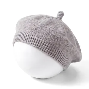 Detailed macro view of a soft grey knitted baby beret hat for infants on white display