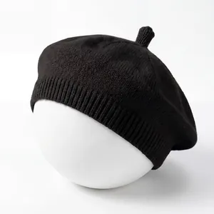 Detailed view of the black knitted baby beret featuring a soft ribbed edge texture