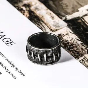 Close-up of vintage stainless steel ring featuring unique stitched pattern design
