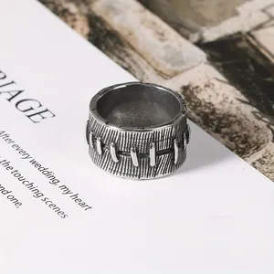 Close-up of vintage stainless steel men's ring with unique stitched suture design