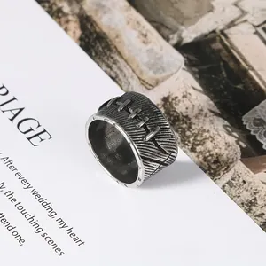 Macro view of vintage stainless steel ring featuring a unique stitched suture design