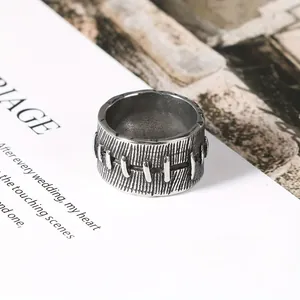 Vintage stainless steel ring with creative stitched texture and a distressed finish.