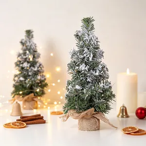 Macro view of snow-flocked mini artificial Christmas tree for tabletop festive decoration