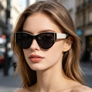 Model wearing stylish black and white cat-eye sunglasses in an outdoor street setting