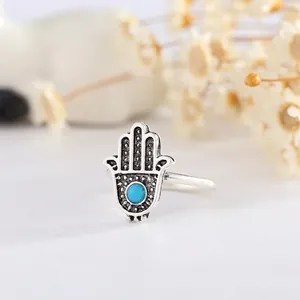 Close-up detail of a vintage silver Hamsa Hand ring featuring a turquoise center stone