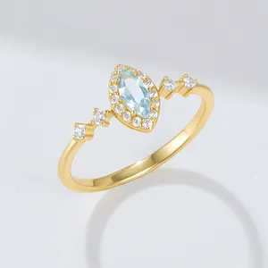 Detailed close-up of a gold-plated 925 silver ring featuring a marquise sky blue topaz stone.