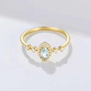 Detailed view of a gold-plated 925 sterling silver ring with marquise-cut sky blue topaz