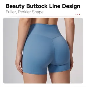 Macro view of light blue high-waisted yoga shorts featuring a sculpted peach hip seam design