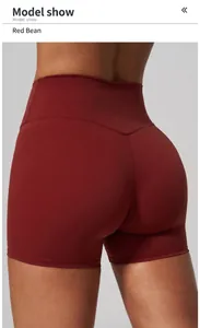 Detailed back view of red high-waisted yoga shorts on a fitness model in studio