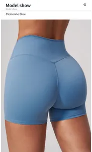 Close-up view of blue high-waisted yoga shorts showing a snug and elastic fit on model