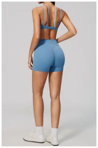 Back view of high-waisted blue yoga shorts on a model in a professional studio setting