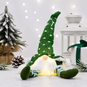 Handmade light-up Christmas gnome plush with long legs in festive holiday setting