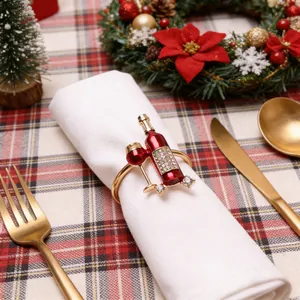 Festive wine bottle and glass napkin ring with rhinestones on Christmas table