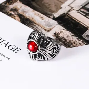 Vintage punk style stainless steel ring featuring a bold red gemstone and ornate engraving
