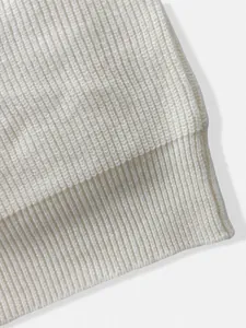 Macro view of the high-quality off-white ribbed knit texture on a men's retro cardigan