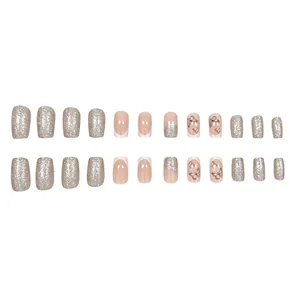 Close-up of 24pcs square press-on nails set with silver glitter and butterfly motifs