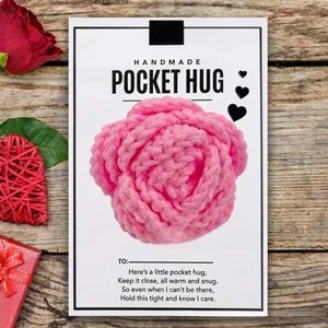 Detail of pink crocheted rose on handmade Pocket Hug poem card with romantic props