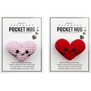 Close-up of handmade crocheted heart pocket hug on greeting cards