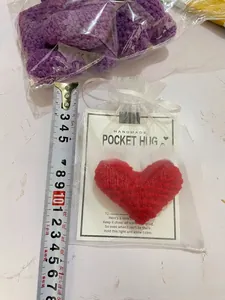 Handmade crocheted red heart pocket hug gift set with greeting card and white mesh bag