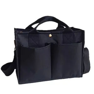 Versatile black multi-compartment mommy bag with large capacity and shoulder strap