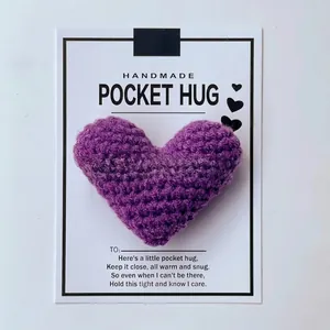 Close-up detail of a purple crocheted heart pocket hug attached to a handmade gift card