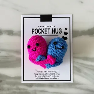 Handmade crocheted pink and blue heart pocket hugs attached to a lovely greeting card