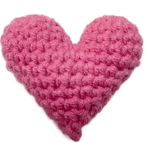 Handmade pink crocheted heart accessory for pocket hugs and creative gift decoration.