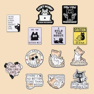 Detailed macro view of funny cartoon cat enamel pins with humorous quotes.