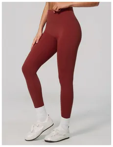 Close-up detail of high-waisted terracotta yoga leggings with smooth elastic fabric