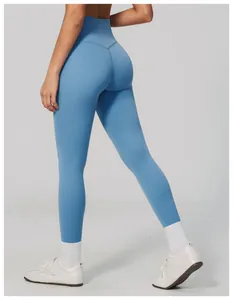 Back view of high-waisted light blue yoga leggings with butt-lifting seam detail
