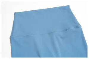 Close-up detail of high-waisted breathable blue yoga pants with flat-lock stitching