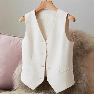 Close-up view of a professional white women's suit vest with V-neck and buttons on a hanger