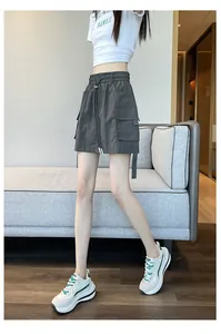 Detail view of grey high-waisted cargo skort with adjustable drawstring and side pockets
