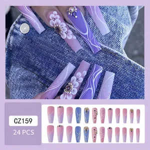 Detail of taro purple press-on nails featuring 3D floral art and sparkling rhinestones
