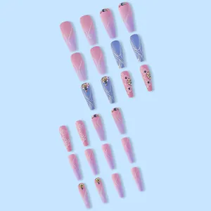 Detail of long coffin press-on nails with taro purple gradient and rhinestone accents.
