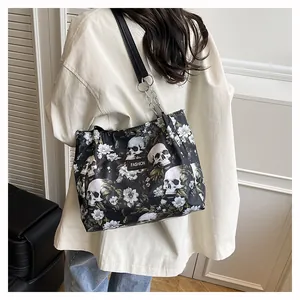 Detailed back view of a stylish skull and floral print tote bag worn on the shoulder
