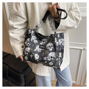 Close-up detail of the vintage skull and white floral pattern on the fashion tote bag