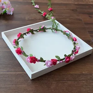 Detailed view of handmade rose flower crown on a white decorative display tray