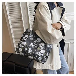 Stylish large capacity tote bag featuring unique skull and floral print worn by a model