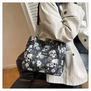 Detail shot of the stylish skull and white floral print tote bag with shoulder strap