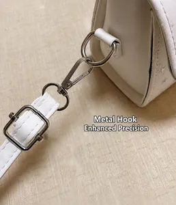 Close-up of the durable metal hook and buckle on elegant white crossbody bag strap.