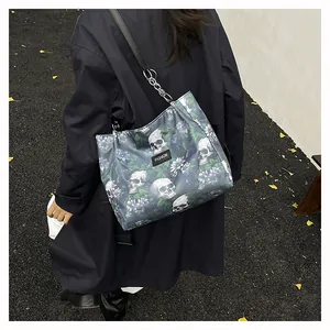 Stylish large capacity shoulder tote bag featuring skull and floral print worn by model