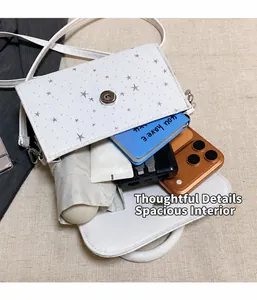 Detail view of white star pattern crossbody bag showing internal storage capacity