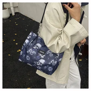 Detailed shot of woman wearing skull and floral print tote bag with beige trench coat