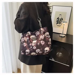Detailed view of women's tote bag with gothic skull and floral print on shoulder
